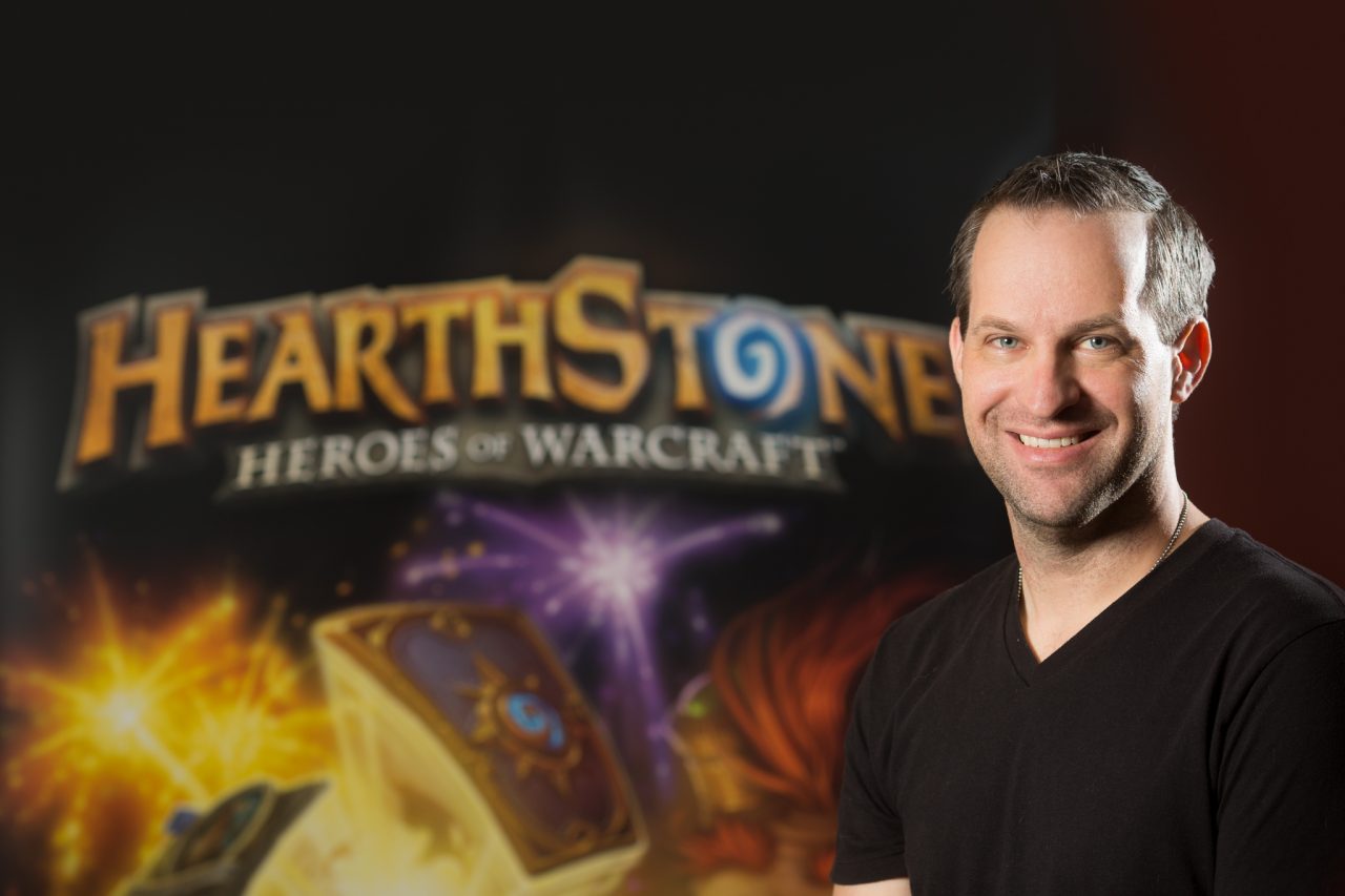 Portrait of a Blizzard Entertainment staff member in front of a Hearthstone: Heroes of Warcraft backdrop.