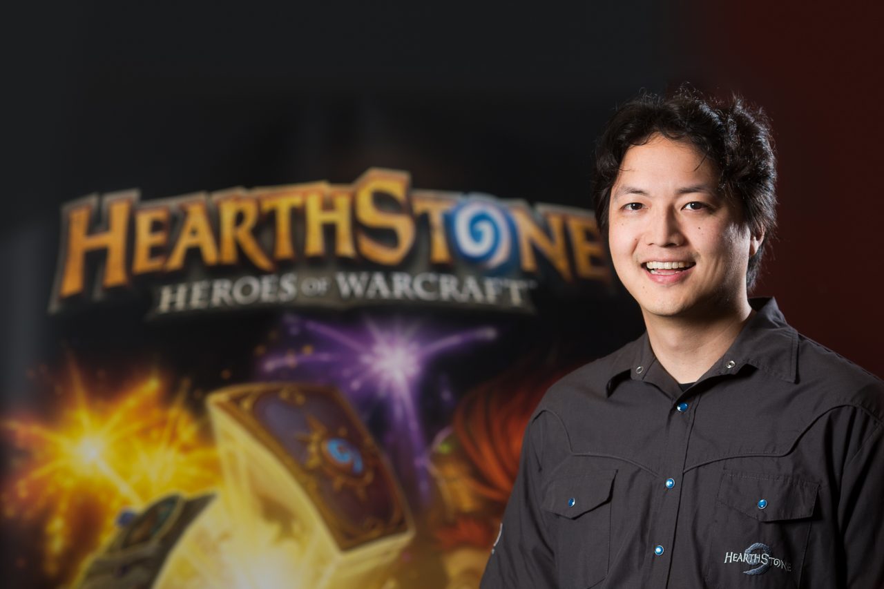 Professional headshot of a Blizzard Entertainment staff member standing in front of a Hearthstone: Heroes of Warcraft backdrop.